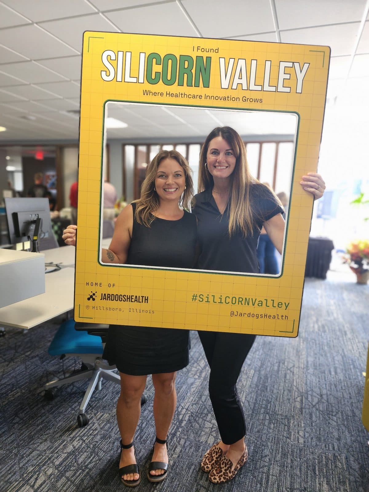 Ashley and Niki with the SiliCORN Valley frame at the Hillsboro office.